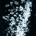 Dynamic macro capture of effervescent water bubbles in a fizzy, sparkling display.